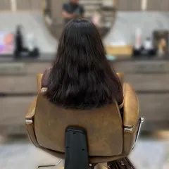 The "before" shot of a global color service. The client's hair is ready for a single-process color to create a uniform and polished look.