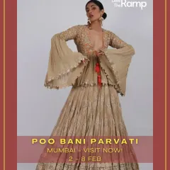 This outfit from our 'Poo Bani Parvati' showcase is a modern take on a classic lehenga. It features a beige printed skirt paired with a unique blouse with dramatic bell sleeves, perfect for making a fashion-forward statement.