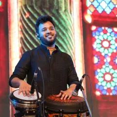A close-up from a soulful concert, playing the Djembe and Darbuka. The background visuals add to the beautiful, traditional ambiance of the event.