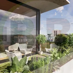 A 3D visualization from the outside looking in. This render shows the patio with comfortable seating and planters, looking into the living room through floor-to-ceiling glass, demonstrating how the garden becomes an extension of the interior.