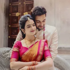 A tender embrace between Siri and Madhusudhan on their engagement day, showcasing their elegant traditional attire and the love between them.