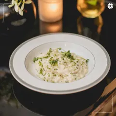 Our refined take on mac and cheese, presented elegantly in a bowl with fresh herbs. We reimagine comfort food classics with a gourmet touch, making them suitable for the most sophisticated celebrations.
