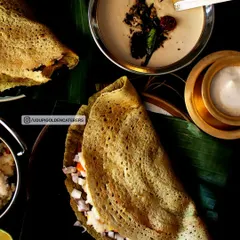 A healthy and flavorful Pesarattu, or green gram dosa, filled with finely chopped onions. This nutritious option is made fresh at our live counters and served with traditional ginger chutney.