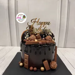 The ultimate chocolate overload cake. This decadent creation is covered in a rich chocolate drip and piled high with Ferrero Rocher, KitKats, and other chocolatey treats.
