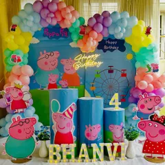 A cheerful Peppa Pig themed birthday party. We created this setup with a colorful balloon arch, custom printed plinths, and cutouts of Peppa and her family for a fun celebration.