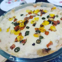 A delicious baked vegetable lasagna, with layers of pasta, creamy white sauce, and colorful veggies, topped with melted cheese.