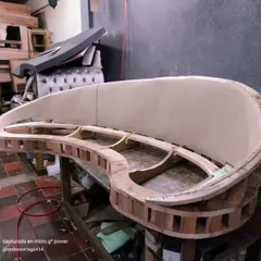 This is the skeleton of a custom curved sofa. I build every frame from solid wood to ensure it is strong and durable, creating the foundation for a piece that will last for many years.