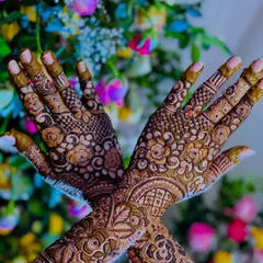 A stunning shot of bridal henna against a colorful floral background, highlighting the beauty of the design.