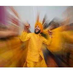 A creative zoom-burst shot of the groom dancing at his Haldi. The motion blur captures the energy and excitement of the moment perfectly.
