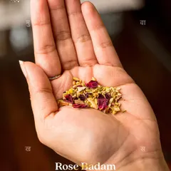A handful of my Rose Badam Desi Mukhwas, showcasing the beautiful mix of ingredients. This blend of rose petals, roasted almonds, and aromatic seeds is a perfect, healthy way to end your meal.