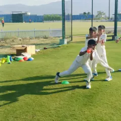 A young player focuses on a close-range catching drill, designed to improve reflexes and hand-eye coordination.