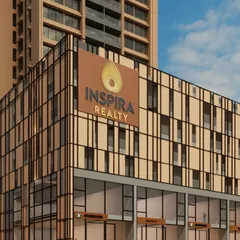 A close-up of the podium level for the Inspira Realty project, highlighting the branding and retail frontage. The facade's geometric pattern and material palette are designed to create an attractive and modern street-level experience for shoppers and residents.