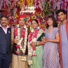 A family portrait with the celebrating couple at their 50th anniversary party, surrounded by their children and grandchildren.
