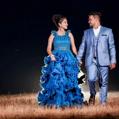 A romantic night shot where the couple's matching blue outfits, both provided by me, create a cohesive and elegant look. Groom styling is a key part of my service.