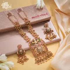 This Maharani Haar is designed to command a room before its wearer even speaks. The grand silhouette features a large, ornate pendant with Bikaneri enamel work, suspended from pearl strands, exuding an aura of sovereignty and exquisite balance.