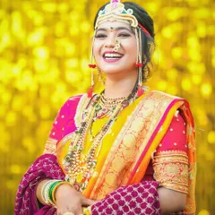 A vibrant and joyful portrait of a bride in her colorful Haldi or wedding attire. The bright yellow background makes her stand out beautifully.