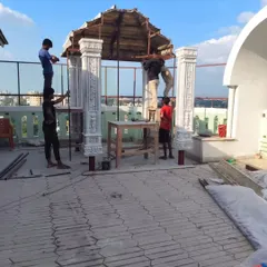 Our skilled craftsmen at work, constructing a custom stone mandir on a client's terrace. Every project, no matter how complex, is handled with precision and expertise.