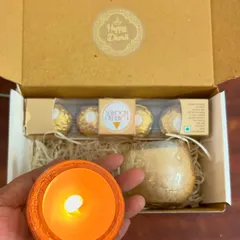 A thoughtful mini hamper for Diwali. This one contains a set of two scented candles in beautiful cracked glass jars and Ferrero Rocher chocolates.