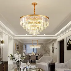 This is how we bring luxury to life. A grand, multi-tiered crystal chandelier installed in a client's living room, creating a stunning centerpiece that complements the high ceiling and elegant decor.