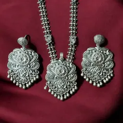 A complete statement set in oxidised silver. This matching necklace and earring set features incredibly detailed floral and leaf motifs, all crafted from pure 925 silver.