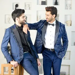 Two distinct but harmonious blue tuxedos. One features heavy silver embroidery for a bold statement, while the other has more subtle detailing, showing the range of customization I offer.