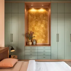 This Japandi-inspired wardrobe features sage green doors with a stunning gold-leafed niche, providing both storage and a beautiful display area.