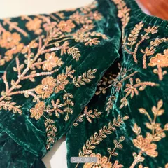 We believe in the power of details. Here, you can see the intricate gold zardosi embroidery, with delicate sequins and French knots, coming to life on a rich emerald green velvet fabric.