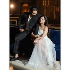 A full-length portrait showcasing the couple's impeccable style. The modern interior, combined with their elegant attire, creates a sophisticated and contemporary pre-wedding photograph.