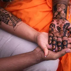 A beautiful, intimate shot of the bride and groom's hands, showcasing the groom's portrait on her arm. This is a wonderfully artistic way to capture the essence of their bond.
