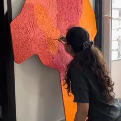 Applying texture to a large, custom-shaped piece. This part of the process is all about building up layers to create depth and dimension.