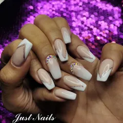 A modern twist on the classic French manicure. This set features a soft pink to white ombre base on coffin-shaped nails, enhanced with delicate silver glitter lines and strategically placed rhinestones at the cuticle for a touch of sparkle.