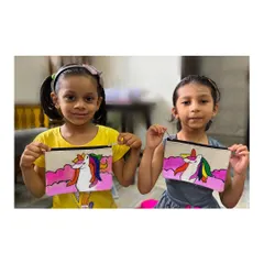 Two proud young artists showing off the unicorn pouches they painted themselves. In my workshops, kids get to create their own personalized accessories to take home and use.