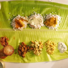 Here you can see the two souls of my Onam offering. The top row showcases the classic vegetarian curries, while the bottom row features the hearty thorans and a crispy cutlet from my UnSadya® menu.