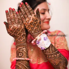 A close-up shot showcasing the incredibly detailed and beautiful mehndi design on the bride's hands, a key part of the pre-wedding celebration.