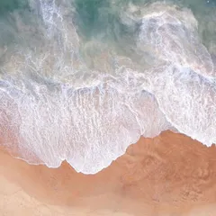Another top-down aerial view of the waves in Goa, capturing the contrast between the turquoise water and the golden sand.