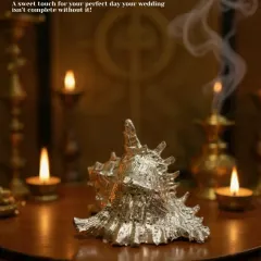 A sweet touch for your perfect day. This silver-plated decorative conch shell, set against a backdrop of diyas, adds a serene and auspicious feel to your wedding decor.