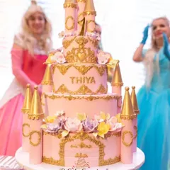 Another grand castle cake for a first birthday. This pink and gold masterpiece features multiple tiers, detailed castle towers, and beautiful floral accents, fit for a little princess.