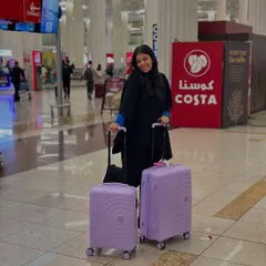 Habibi, we're in Dubai. My airport look is all about comfort, with a black co-ord set and my trusty lavender suitcases.