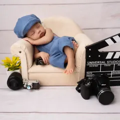 Lights, camera, action! A future director in the making with this fun, movie-themed newborn setup, complete with a tiny clapperboard and cameras.