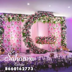 For a truly special naming ceremony or baby shower, we designed this breathtaking floral swing. The crescent moon shape, covered in soft pink and white flowers against a rose-patterned backdrop, creates a magical setting to welcome your little one.