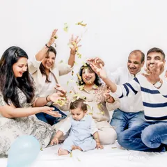 A joyous celebration with the extended family. Throwing confetti and sharing laughter, this image captures the vibrant energy and happiness of a family coming together for a special milestone.