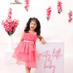 A 'Pretty Little Baby' indeed. This three year old birthday girl shines in her beautiful pink dress against a clean, modern studio backdrop with floral accents.