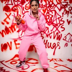 A bold and energetic pose against our custom graffiti wall. This setup is perfect for streetwear brands, hip-hop concepts, or anyone wanting a vibrant, urban feel for their shoot.