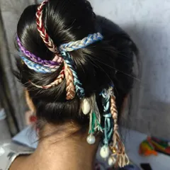 This is how you can style my boho hair extensions into a beautiful bun. The mix of colors, shells, and pearls creates a unique and festive look, perfect for weddings or Navratri celebrations.