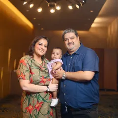 A happy family of three posing in a beautifully lit hallway. This is a great example of a simple, classic family portrait that you will cherish.