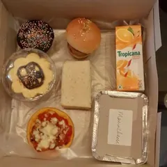 A clear shot of the contents, showing how each item is carefully placed. From the savory sandwich to the sweet cupcake, it's a balanced meal that kids genuinely love to eat.