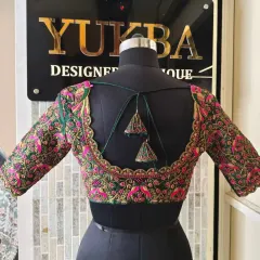 A full back view of the emerald green scalloped blouse, showing the symmetry of the design and the delicate matching tassels. This is a perfect example of a heavily embroidered yet elegant piece.