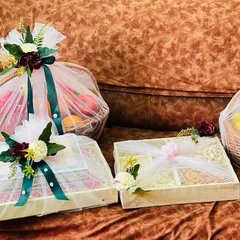 Here you can see the variety in a single trousseau project, including a large fruit basket, a compartmentalized dry fruit box, and other gift boxes. Each is wrapped to complement the others.
