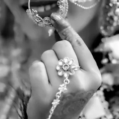 An artistic close-up in black and white, highlighting the bride's smile and her traditional nose ring.