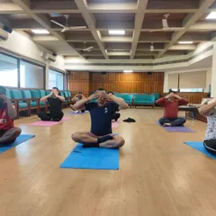 Students practicing Bhramari pranayama, the humming bee breath, during an international teacher training course. This practice is excellent for calming the mind, relieving stress, and improving concentration by creating soothing internal vibrations.